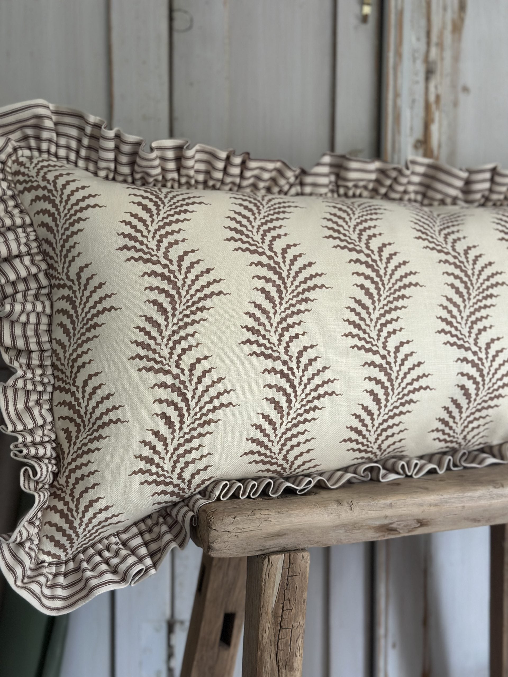 Scrolling fern and ticking stripe lumber cushion